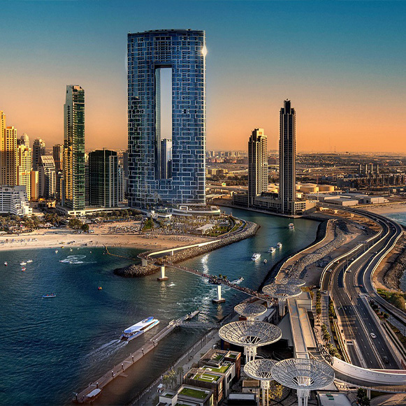 A photo of the Muscat corniche in the night time with city lights sparkling