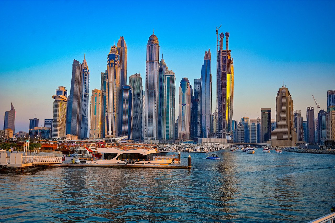 Many boats cruise on the horizon of the coast in DUBAI